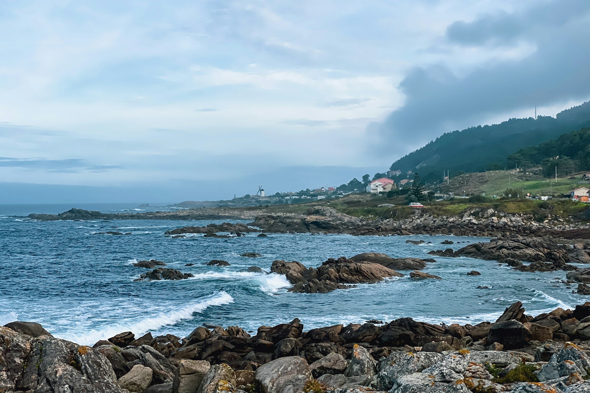 Rocky Atlantic shoreline and a Galician coastal settlement