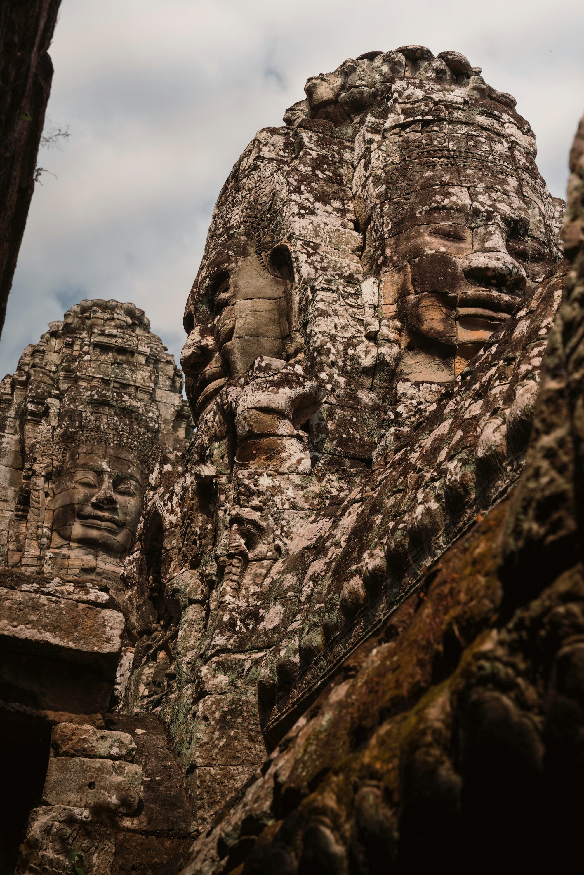 Bayon Temple iconic stone faces carved into ancient towers with serene smiling expressions