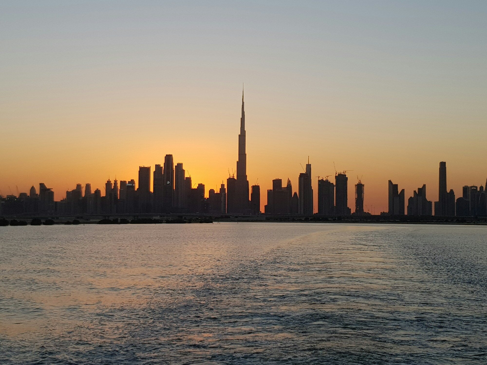 Dubai Marina skyline across the water at sunset